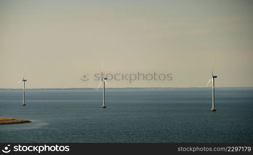 Wind turbines generator farm for renewable sustainable and alternative energy production along coast baltic sea near Denmark. Eco power, ecology.. wind turbines farm on coast