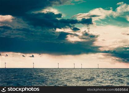 Wind turbines generator farm for renewable sustainable and alternative energy production along coast baltic sea near Denmark. Eco power, ecology.. Wind turbines farm in Baltic Sea, Denmark