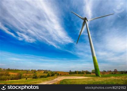 wind turbines in fields under blue sky