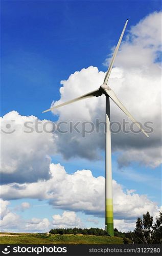 wind turbines in the fields under blue sky