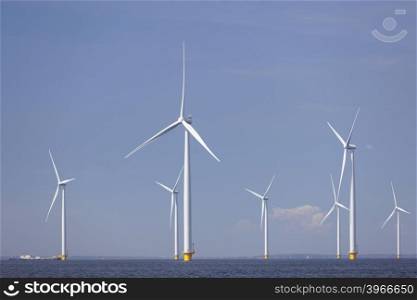 wind turbines in water of ijsselmeer off the coast of flevoland with blue sky in the netherlands