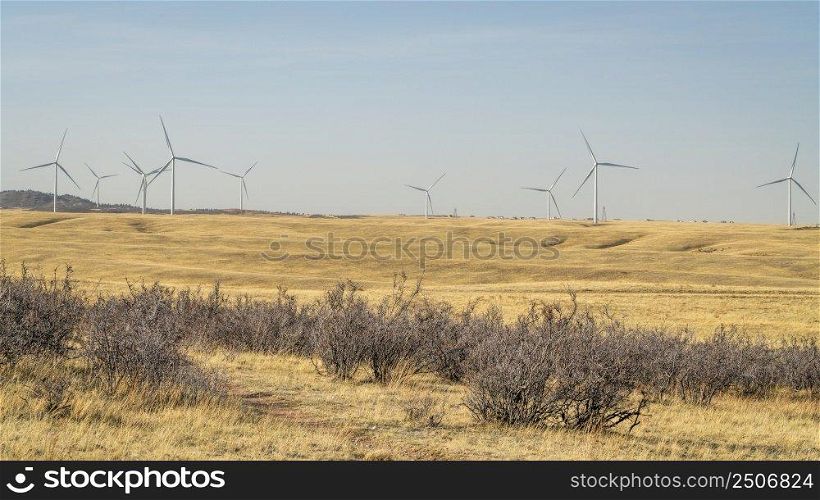 wind turbines in Wyoming prairie as seen from the Cheyenne Rim bike trail in Soapstone Prairie Natural Area in Colorado, early spring scenery