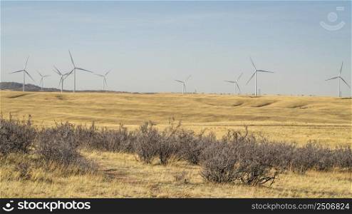 wind turbines in Wyoming prairie as seen from the Cheyenne Rim bike trail in Soapstone Prairie Natural Area in Colorado, early spring scenery