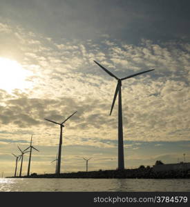 wind turbines power generator farm for renewable energy production along coast baltic sea near Denmark at sunset /sunrise. Alternative green energy. ecology.