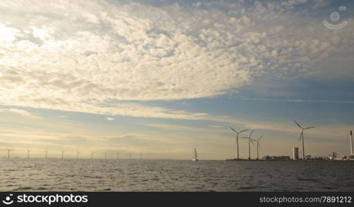 wind turbines power generator farm for renewable energy production along coast baltic sea near Denmark. Alternative green clean energy, ecology.