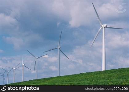 Windfarm clouds and green meadow