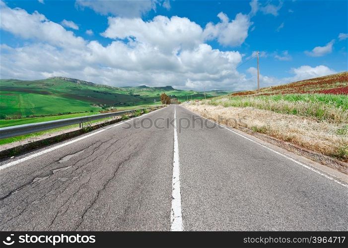 Winding Asphalt Road between Autumn Plowed Fields of Sicily