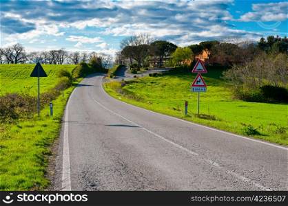 Winding Asphalt Road between Fields in Italy