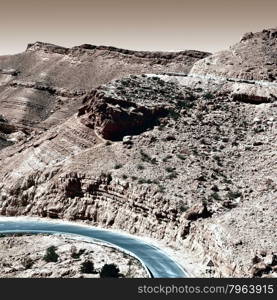 Winding Asphalt Road in the Negev Desert in Israel, Vintage Style Toned Picture