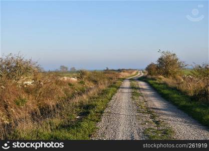 Winding gravel road in the countryside at the swedish island Oland