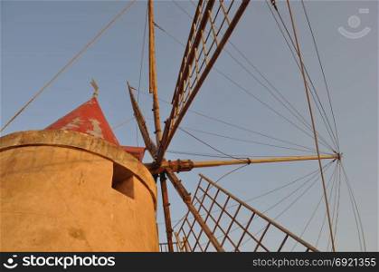Windmill at saline (Salt flats) in Marsala. Wind mill at saline (meaning Salt flats) in Marsala, Italy