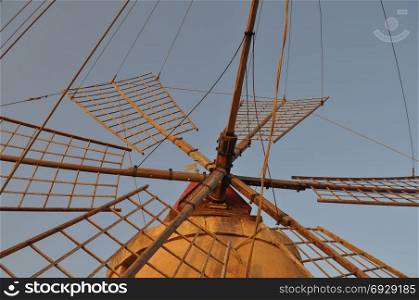Windmill at saline (Salt flats) in Marsala. Wind mill at saline (meaning Salt flats) in Marsala, Italy