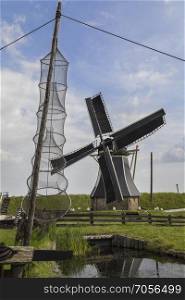 Windmill in a reconstruction of a 19th century Dutch fishing village at the Zuiderzee Open Air Museum in the Netherlands