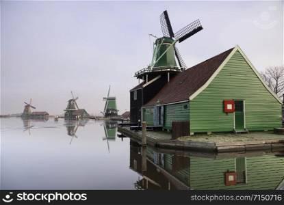 Windmill in the Dutch traditional village Zaanse Schans which is one of the busiest tourist locations in the Netherlands. Windmill in the Zaanse Schans
