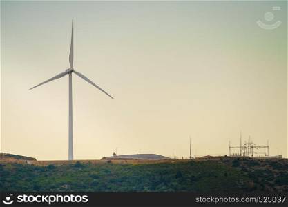 Windmill on Greek hills. Wind farm, source of renewable green energy in Europe. Ecologogy concept.. Windmill on Greek hills