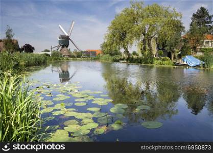 WIndmill on the Graafstroom river. Windmill on the rural river Graafstroom in the Dutch village Bleskensgraaf