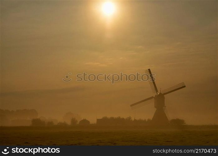 Windmill the Wingerdse Molen near the Dutch village WIjngaardem on a beautiful misty morning. Windmill the Wingerdse Molen on a misty morning