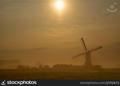 Windmill the Wingerdse Molen near the Dutch village WIjngaardem on a beautiful misty morning. Windmill the Wingerdse Molen on a misty morning