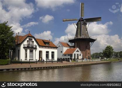 Windmill the Zwaluw along the river Dokkumer Ee in the frisian village Burdaard. Windmill the Zwaluw