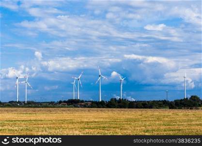 windmills for electric power production. Wind turbines on the beautiful autumn meadow