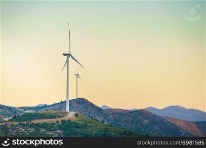 Windmills on Greek hills. Wind farm, source of renewable green energy in Europe. Ecologogy concept.. Windmills on Greek hills