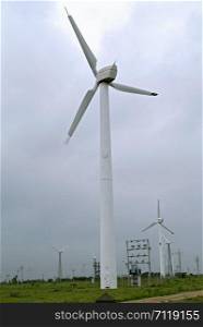 Windmills standing of a field.