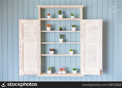 Window Flower box with beautiful flowers on blue wood background