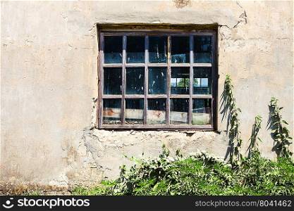 window in old shabby building in sunny summer day