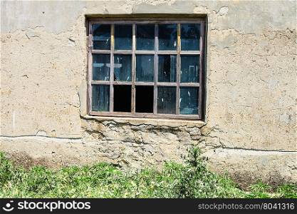window in wall of abandoned building in sunny day