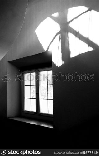 window of a mansion with a wide window sill on a spiral staircase leading to the courtyard