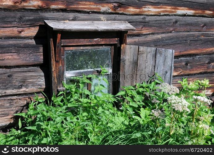 Window of abandoned bath-house in remote Russian village