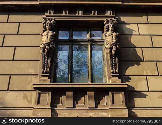 Window of old building with caryatids in Odessa, Ukraine