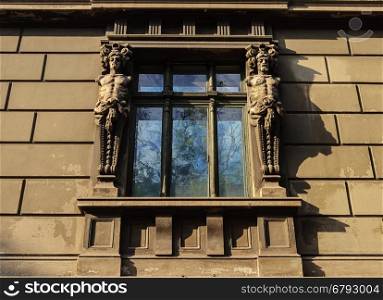 Window of old building with caryatids in Odessa, Ukraine
