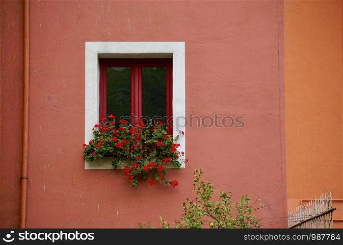 window on the red facade of the buildin in Bilbao city Spain