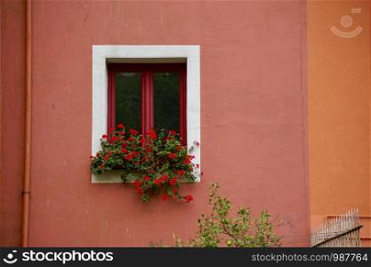 window on the red facade of the buildin in Bilbao city Spain