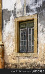 Window on the side of an old church in colonial architecture in the historic city of Ouro Preto in Minas Gerais. Window on the side of an old church in colonial architecture