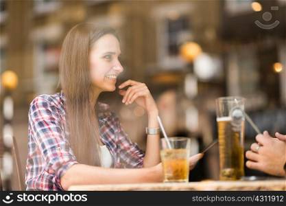 Window view of young couple in bar