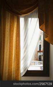 Window with drapes in Venice, Italy.