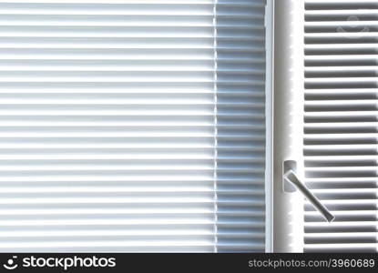 Window with white jalousie. Element of interior design.