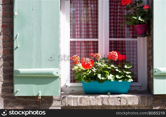 Window with wooden shutters decorated with flowers