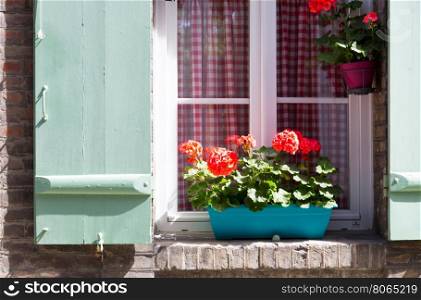 Window with wooden shutters decorated with flowers