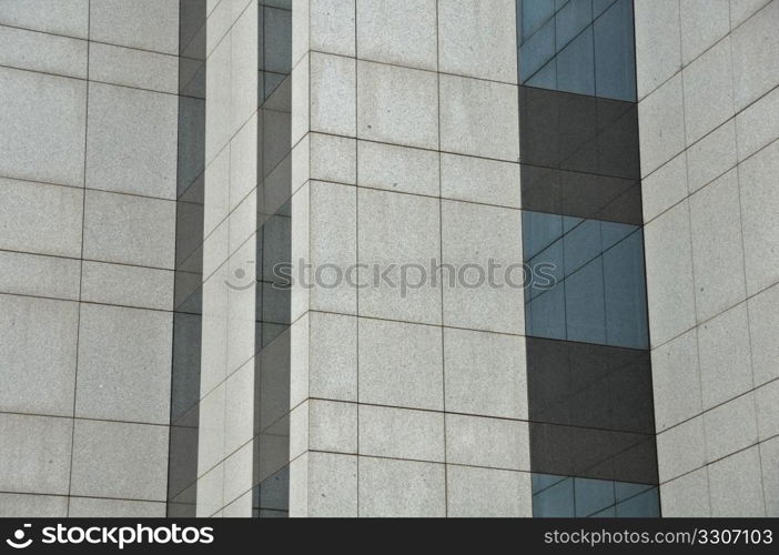 Windows and wall of a modern glass building. Architectural detail.