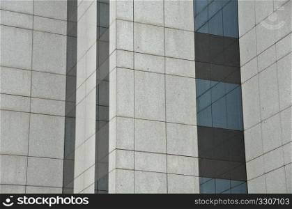 Windows and wall of a modern glass building. Architectural detail.