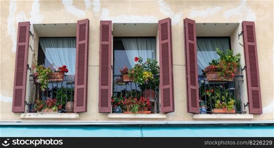 Windows in an old house decorated with flowers