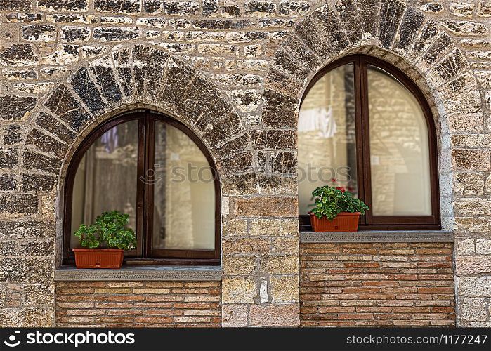 windows in the facades of ancient medieval houses