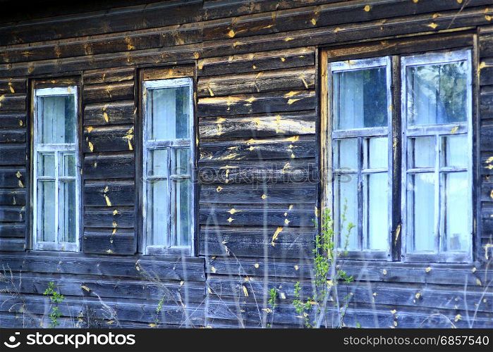 windows of the old rural wooden house. The windows of the old rural wooden house
