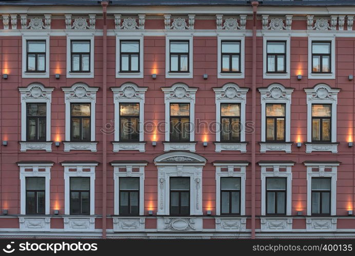 Windows on the facade of the historic building with reflections