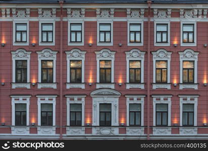 Windows on the facade of the historic building with reflections