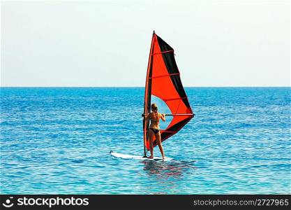 windsurf - surfer girl on blue sea surface