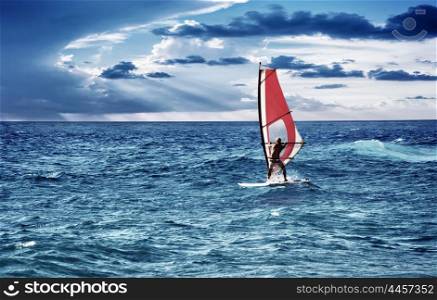 Windsurfer in the sea, man on windsurf conquering the waves, enjoying extreme sport, active lifestyle, happy summer vacation&#xA;
